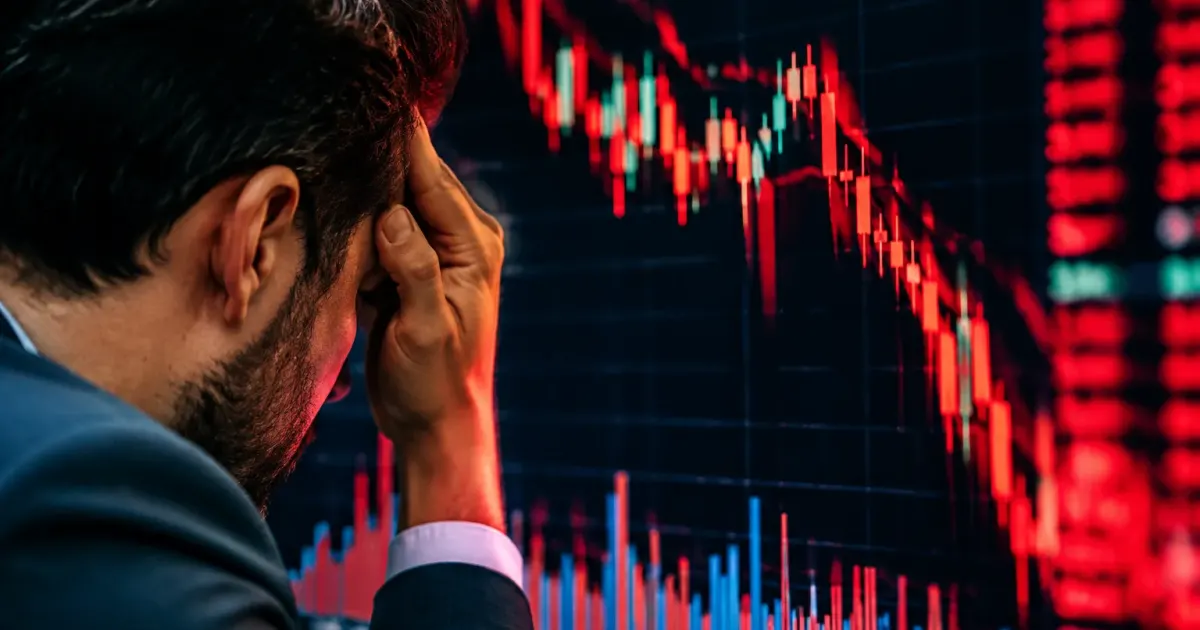 Numeri rossi cadono verticalmente su monitor finanziario scuro