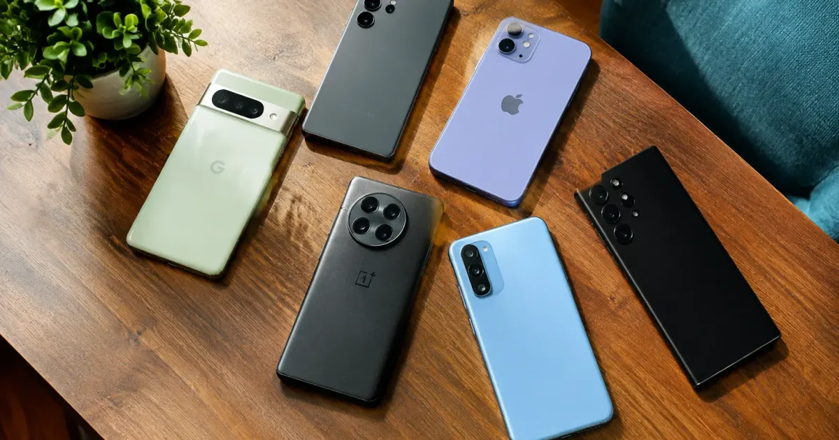 Diverse smartphone models displayed side by side on table
