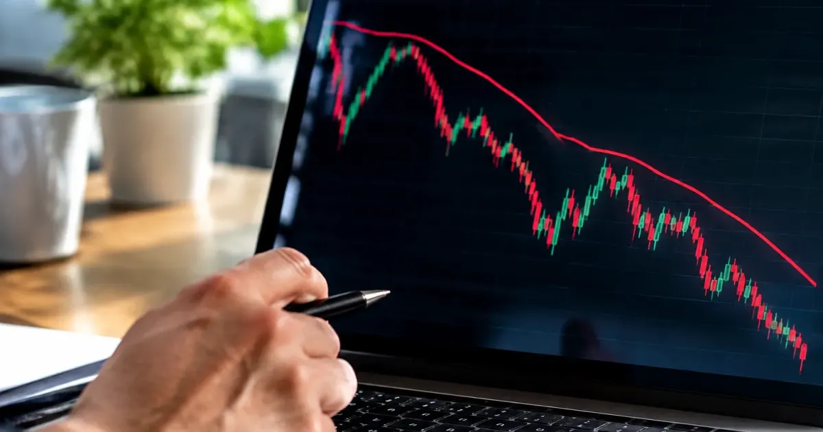 Linea rossa su schermo trading scende verso zona critica